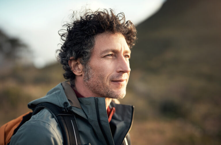 Shot of a mature man going for a hike up a mountain